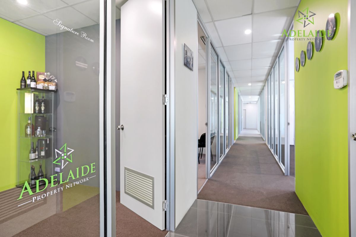 A hallway in the Blair Athol office with the Adelaide Property Network logo