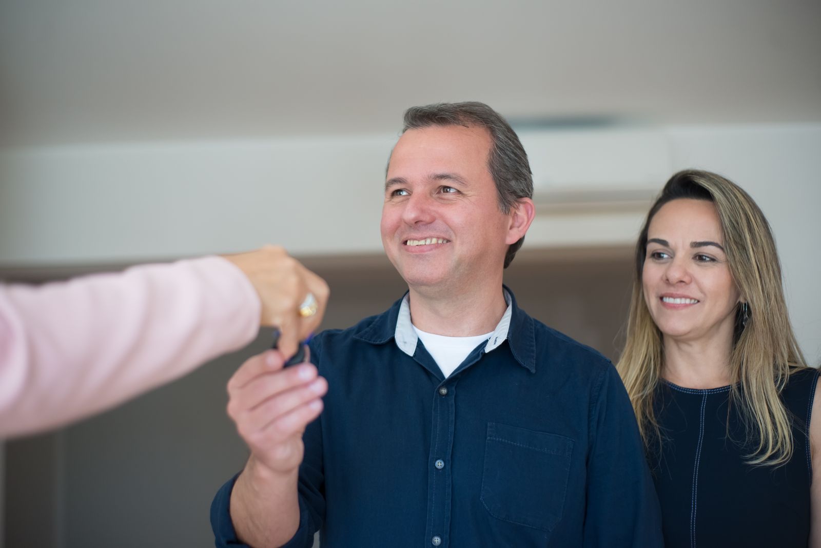 A couple being handed a set of house keys